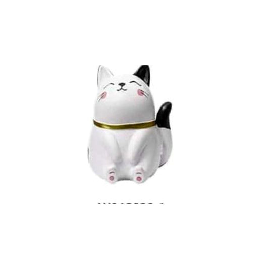 The Daydreamer: seated white-and-black Chubby Cat figurine with chin raised, eyes closed and gold-tone collar.