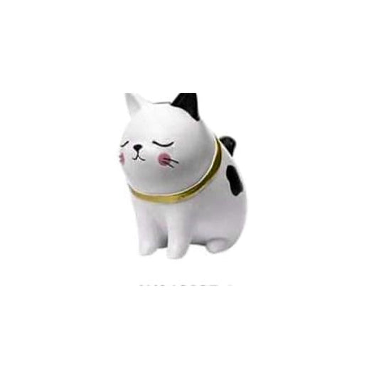 The Lounger: white-and-black cat figurine leaning gently sideways, eyes closed, with a gold-tone collar.