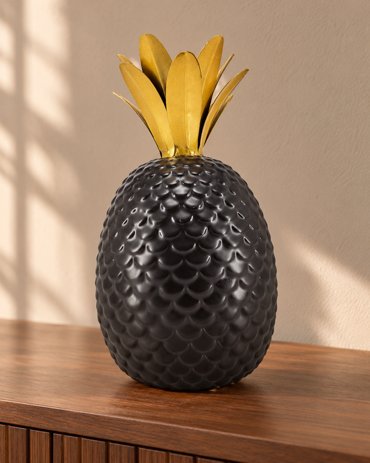 Charcoal ceramic pineapple with rounded scale texture and gold-tone crown