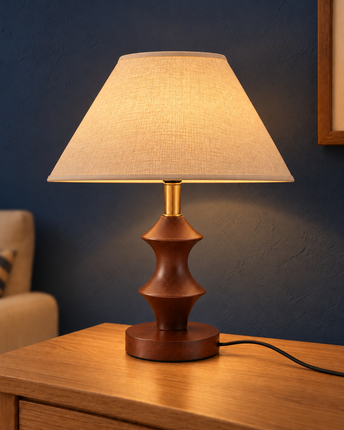 Column table lamp illuminated on an oak console against a blue wall