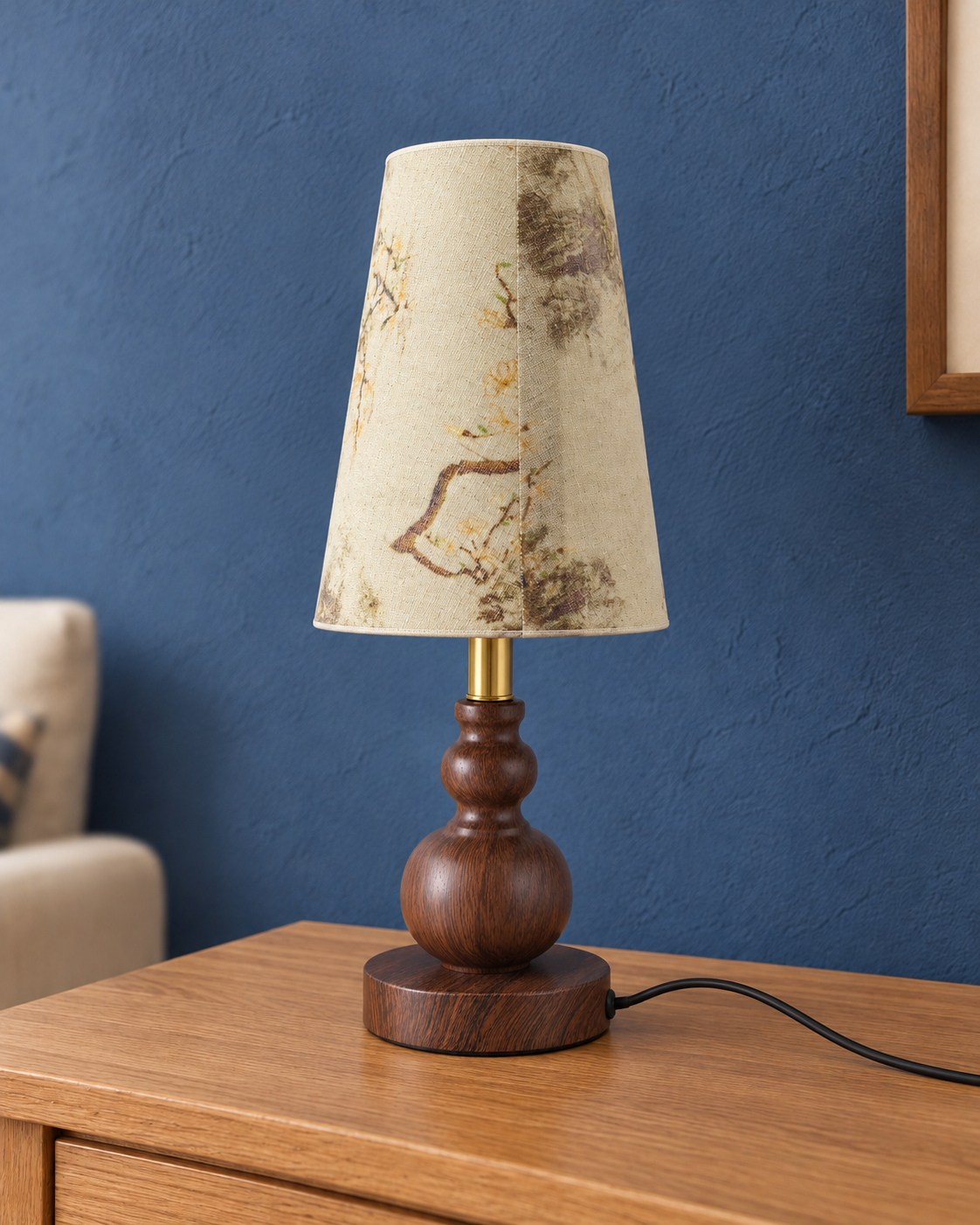 Spindle metal table lamp with wood-look finish, gold-tone stem and narrow patterned shade, unlit