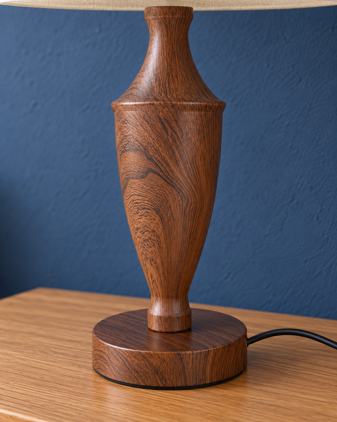 Close-up of the Vase lamp metal base with its patterned brown wood-look coating