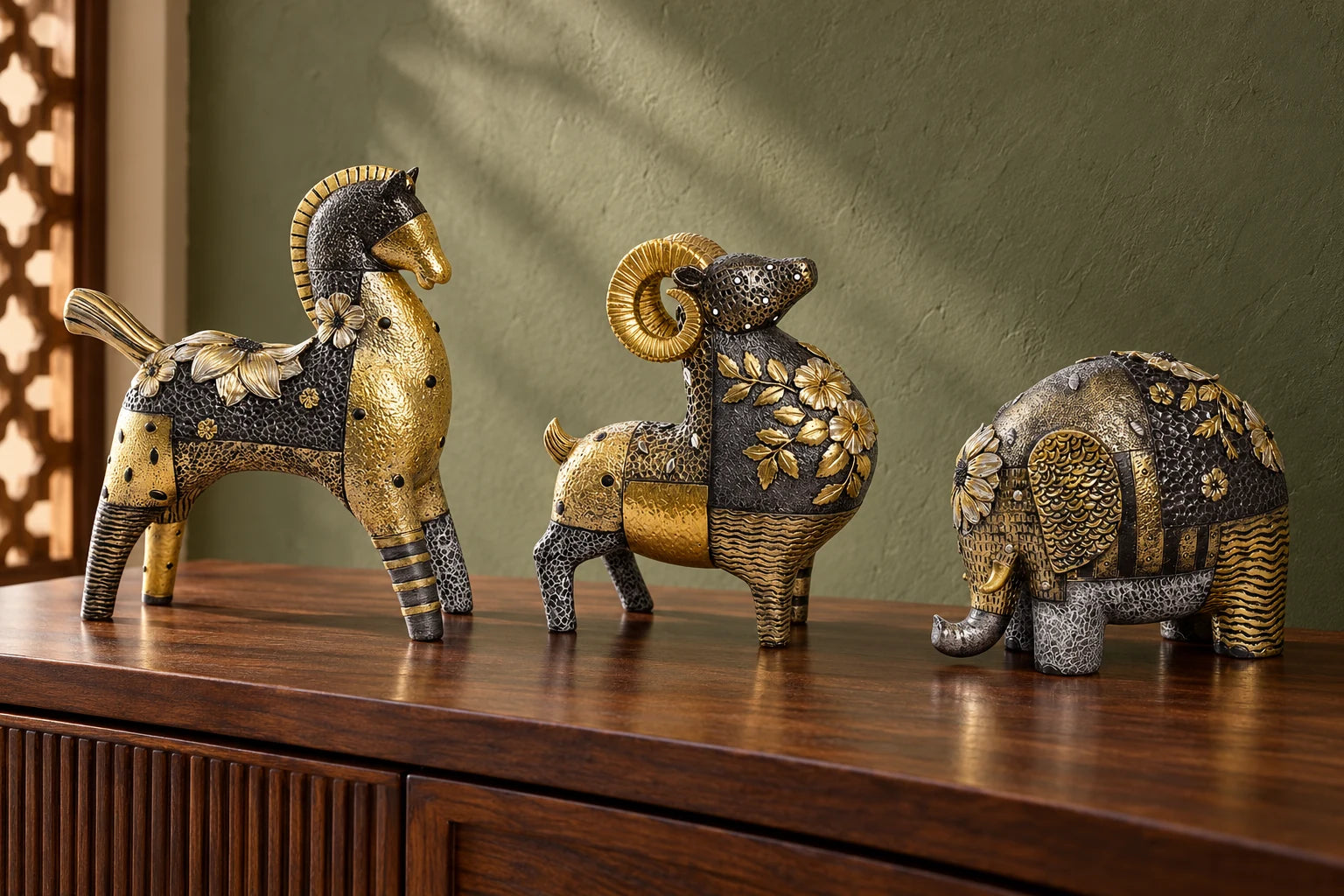 Gilt Sprig horse, ram and elephant styled together on a walnut console